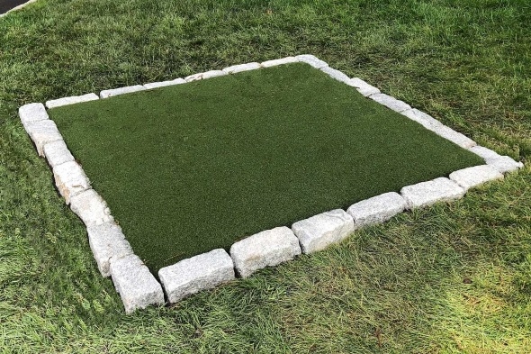 Edmonton Tee box made of synthetic grass surrounded by stone border